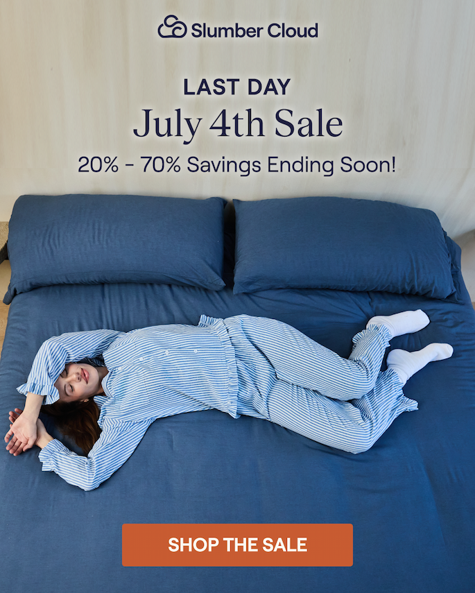 A woman stretched out on a bed made with Slumber Cloud and Avec bedding