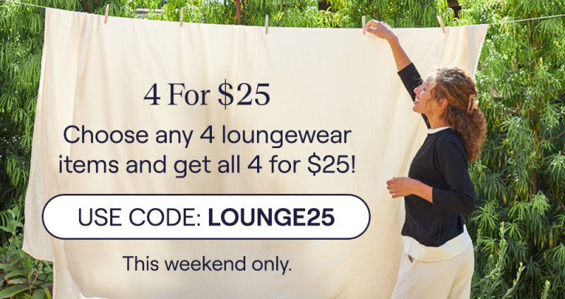 A woman wearing the UltraCool Raglan Long Sleeve while hanging up a sheet to dry
