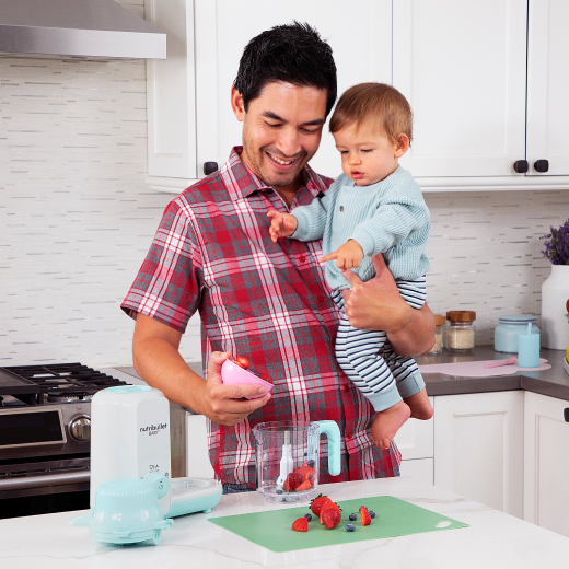 Dad holding baby blending