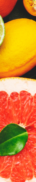 Various citric fruits in the background.