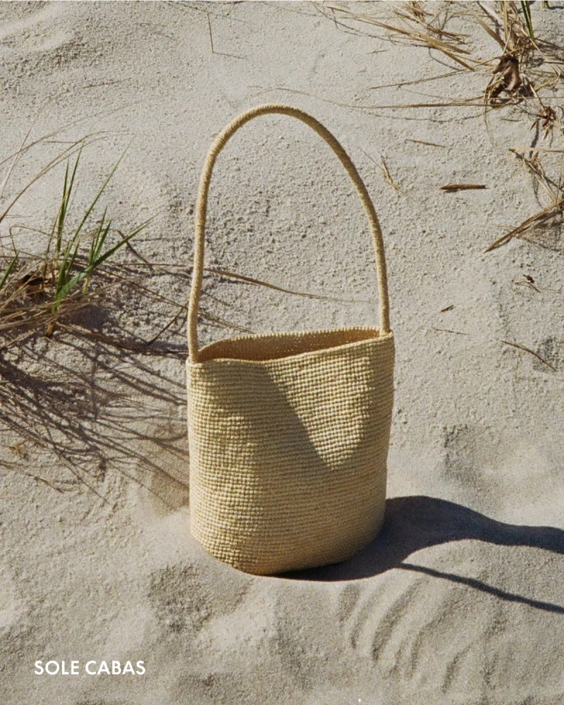 Created in partnership with a small, female-founded nonprofit organization, this capsule supports artisan employment, children's education, rainforest regeneration, and wildlife conservation in Madagascar. Available exclusively at mansurgavriel.com in limited quantities.
