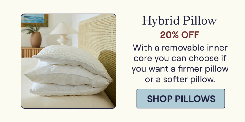 A Hybrid Pillow sitting on a bed unzipped to highlight the removable inner core