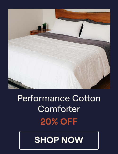 The Lightweight Performance Cotton Comforter on a bed