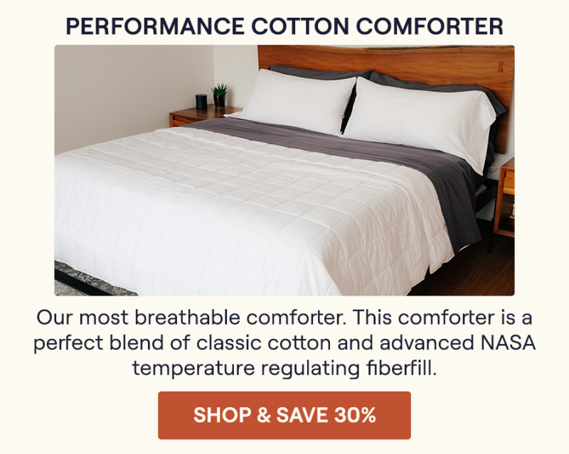 The Lightweight Performance Cotton Comforter on a bed