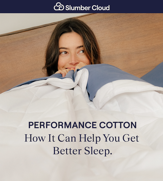 A woman laying in bed hugging the Lightweight Performance Cotton Comforter