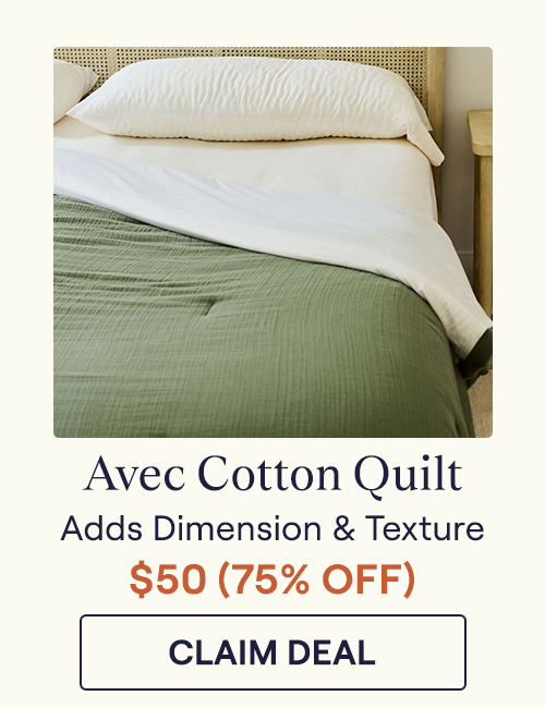 A Moss green Cotton Quilt on a bed with an off-white sheet set