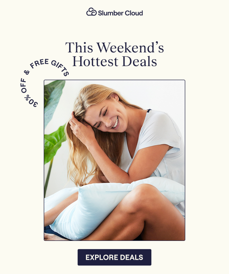 A woman sitting on a bed with the UltraCool Comforter in her lap