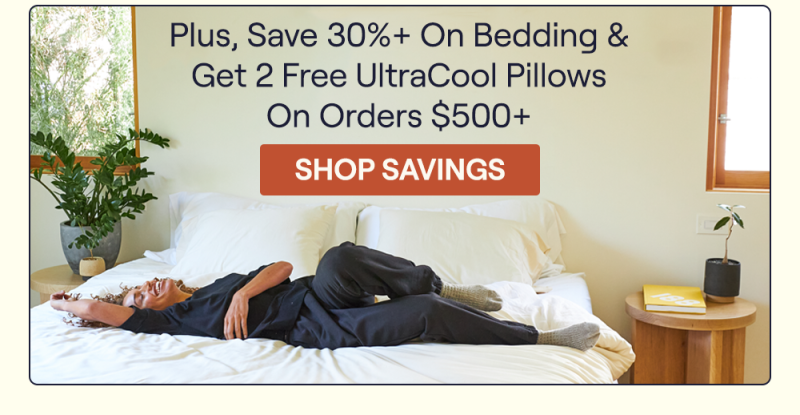 A woman laying on a bed with Slumber Cloud bedding