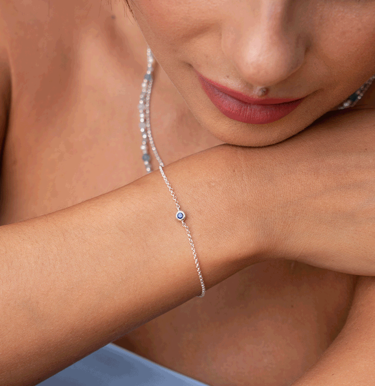 Model wears Sapphire Array Disc Earrings and Single Sapphire Dewdrop Bracelet