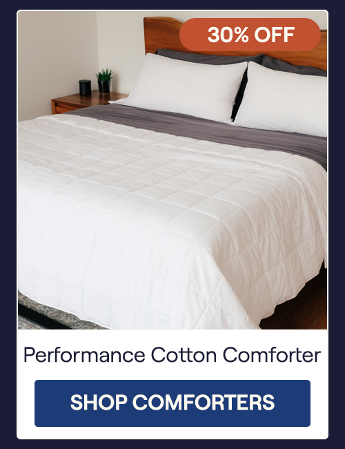 The Lightweight Performance Cotton Comforter on a bed