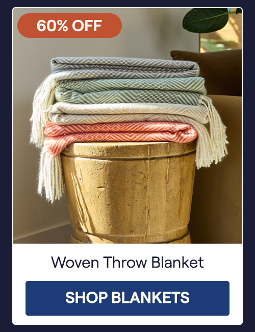 A stack of the Storm, Juniper, Almond, and Brick Woven Throw Blankets on a stool