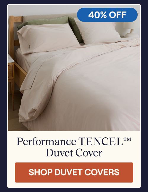 A Sand Performance TENCEL Duvet Cover on a bed along with the Sand Performance Cotton Sheets