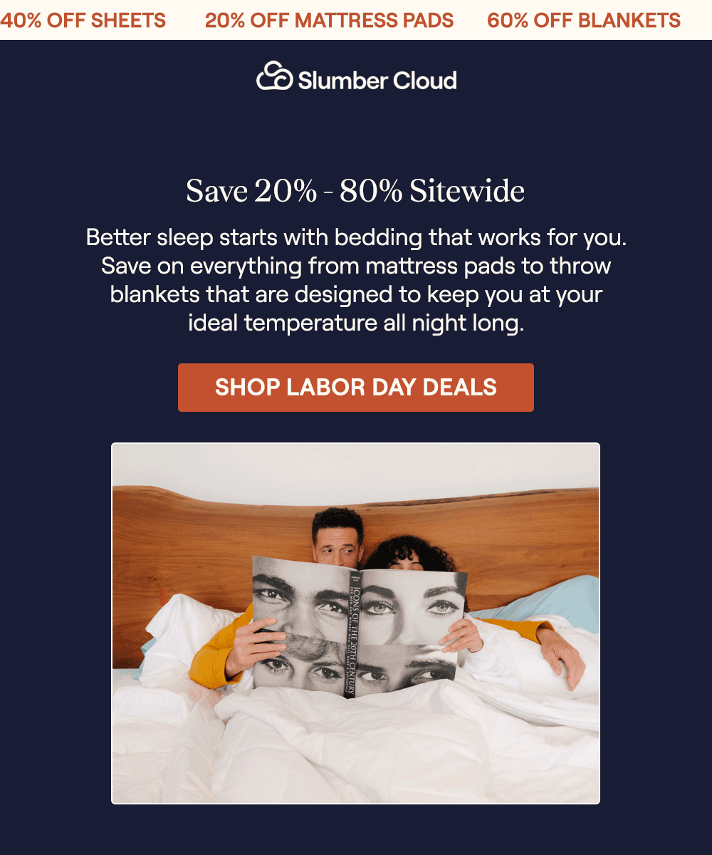 A man and woman laying in bed with the Performance Cotton Comforter reading a book