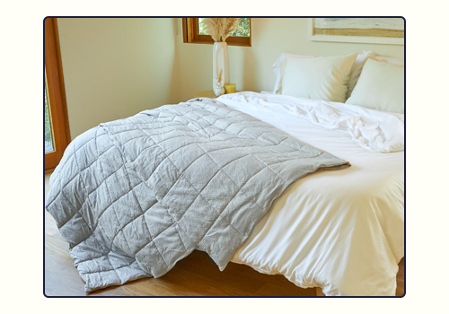 A lunar Textured Blanket laying over the side of a bed