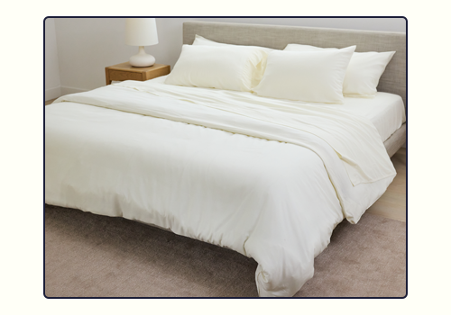 A bed made up with the Bone Performance Linen Blend Sheets and Duvet Cover