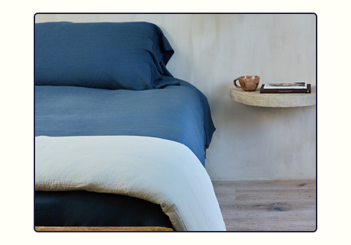 The Harbor Align Sheet Set with a Mist Cotton Quilt folded on the edge