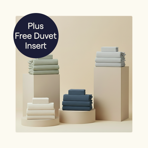 Harbor, Bone, Sage, and Fog Align Sheet Sets sitting folded on pillars
