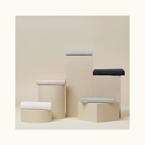 Sand, White, Dove, Navy, and Alice Performance TENCEL™ Duvet Covers folded on pillars