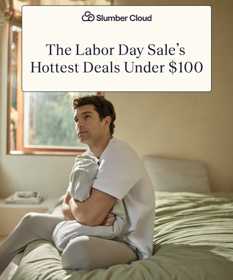 A man sitting on a bed hugging a pillow with the Align Sheet Set
