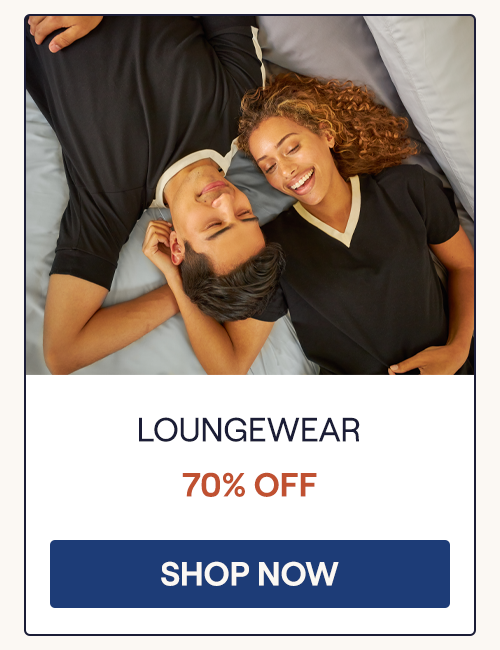 An overhead view of a man and woman laying on a bed with the woman wearing the UltraCool V-Neck and the man wearing an UltraCool Raglan Pullover Tee
