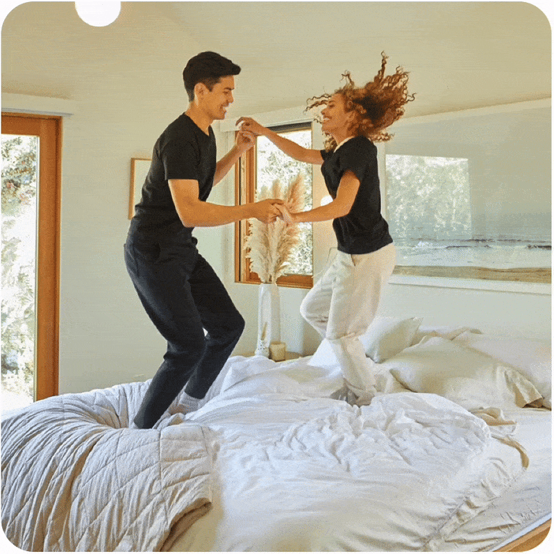 Couple jumping on a bed