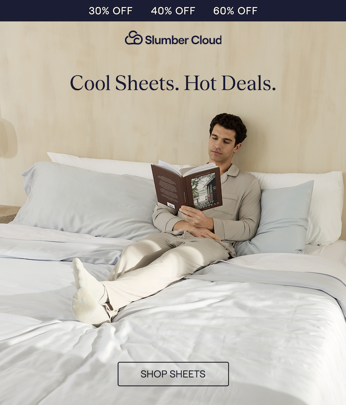 A Man laying in bed with Slumber Cloud Alice Blue Performance TENCEL Sheets while reading a book.
