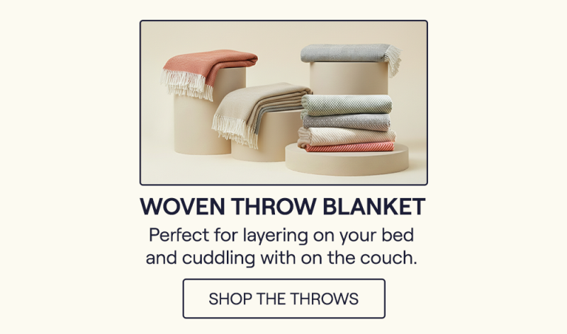 The Brick, Juniper, Storm, and Almond Woven Throw Blankets sitting on pillars
