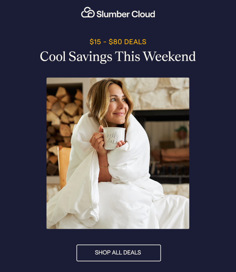 A woman wrapped up in a comforter and duvet cover drinking a cup of coffee