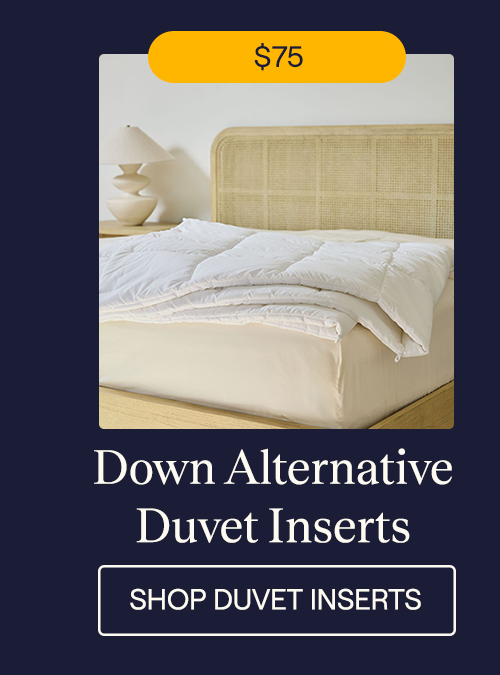 A Down Alternative Duvet Insert draped over the edge of the bed