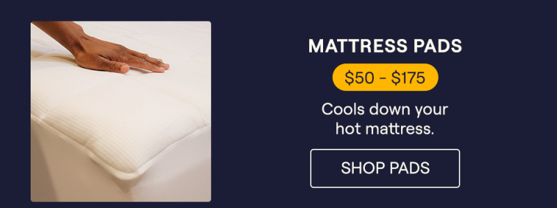 A man's hand resting on the Performance Mattress Pad