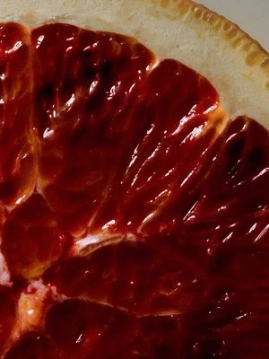 A deep red quarter slice of blood orange