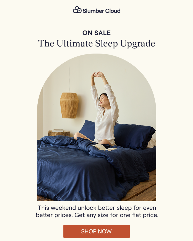 A woman stretching in bed with the Navy Performance TENCEL sheets & duvet cover