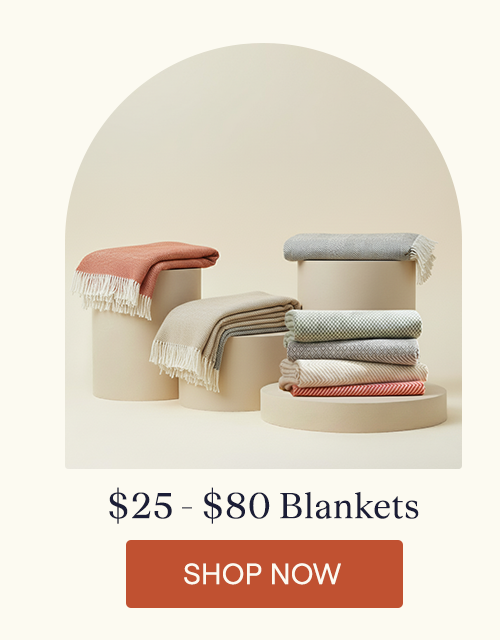The Woven Throw Blankets sitting on pillars