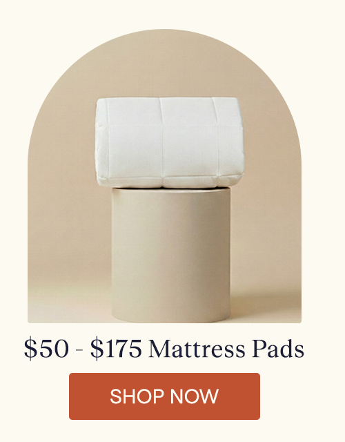 The Performance Mattress Pad folded sitting on a pillar