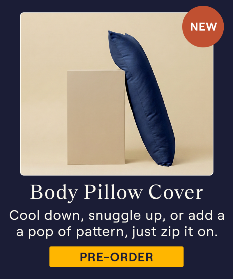 The UltraCool Body Pillow with the Performance TENCEL Body Pillow Cover in Navy on it leaning against a pillar
