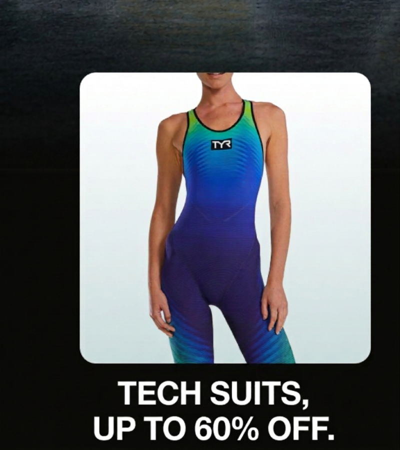 A woman in a blue and green TYR tech suit, on sale up to 60% off.