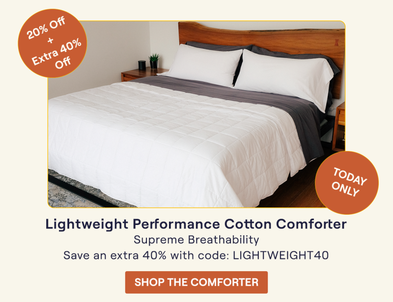 A bed made with the Lightweight Performance Cotton Comforter