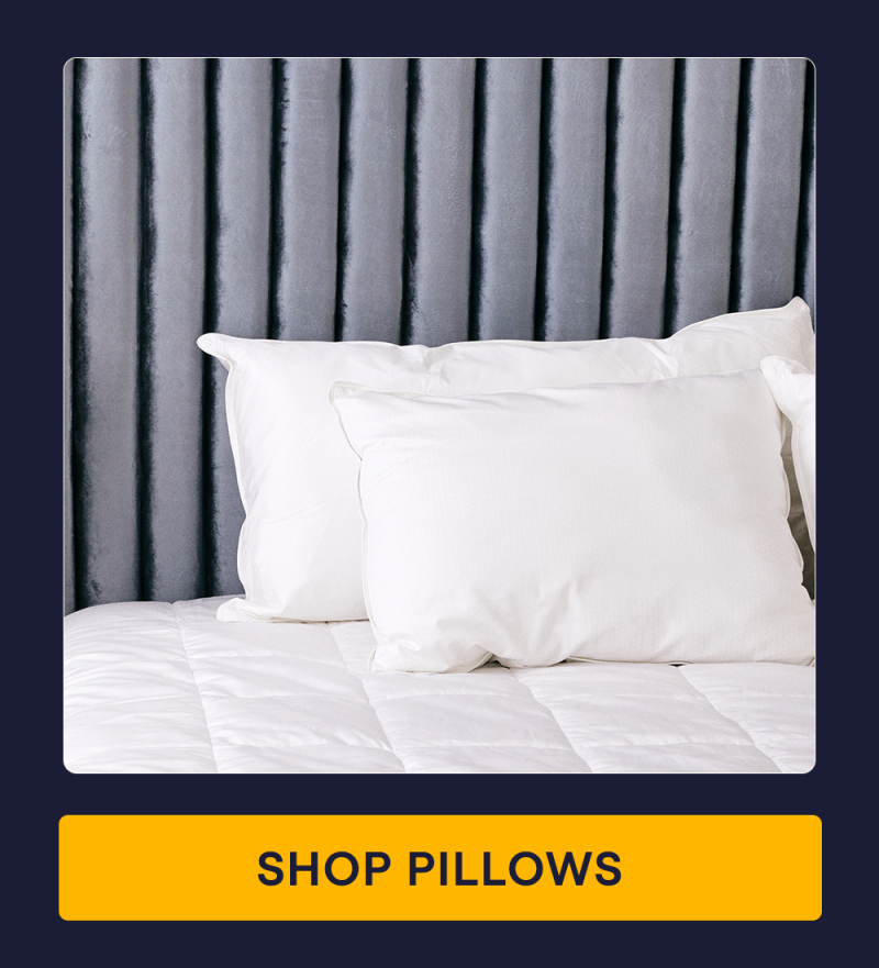 A bed with the Core Down Alternative Pillows on it