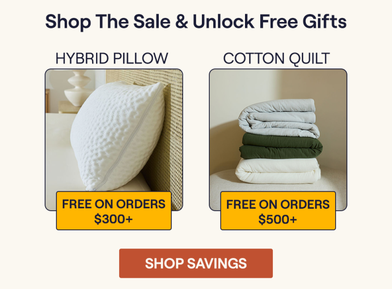 The Hybrid Pillow sitting on a bed and a stack of the Cotton Quilts sitting on a bench